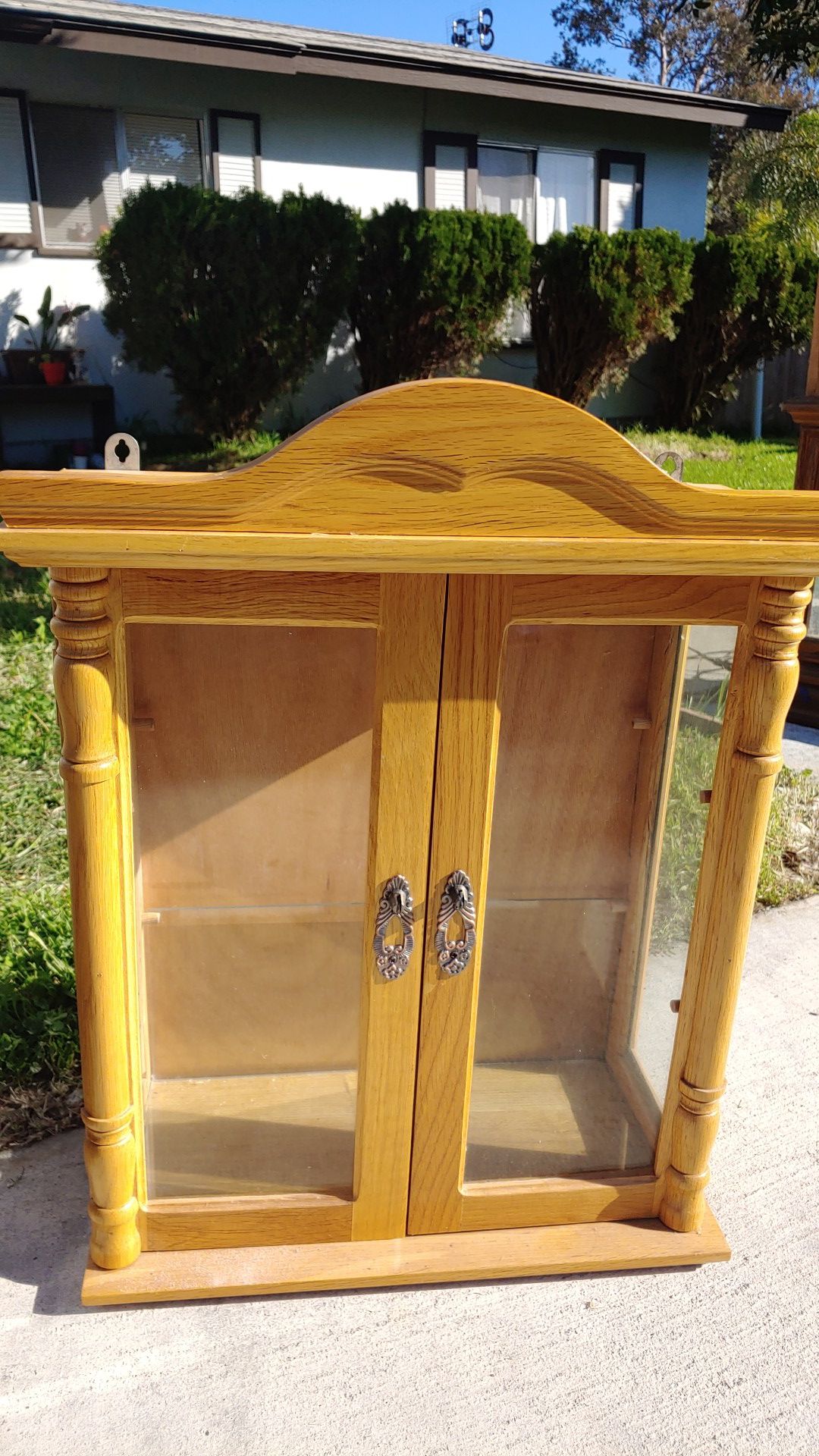 Small wooden cabinet with glass shelf on onside