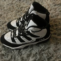 This is a pair of Fila Skyraider IV basketball shoes in black and white. Size: 9 1/2 In Women’s