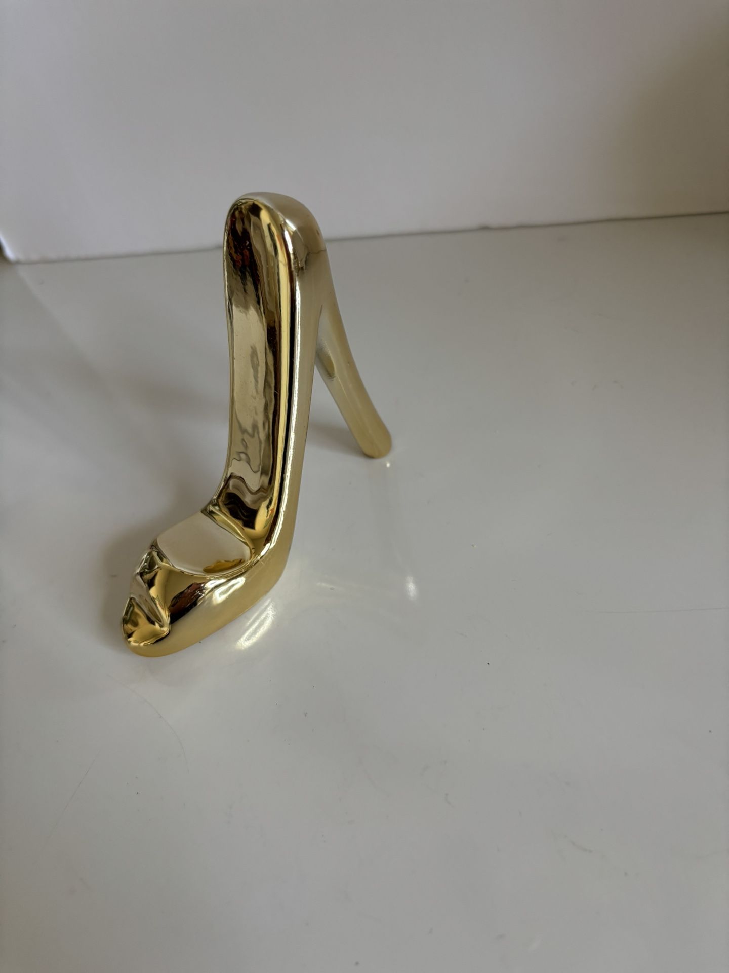 Small ceramic gold color stiletto. New. 3”3/4 by 3”1/4 by 1”. Comes from a smoke free environment.