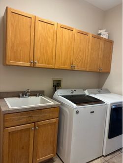 Laundry room, cabinets, and sink