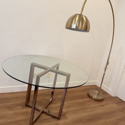 CB2 Silverado 47" Round Brass Dining Table + West Elm 80” Overarching Metal Shade Floor Lamp