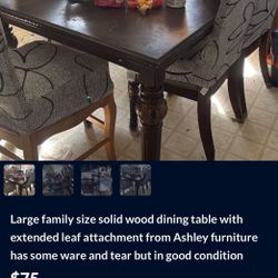 Ashley Solid Wood Table Seats 12 Has Nice Big Extension Leaf.