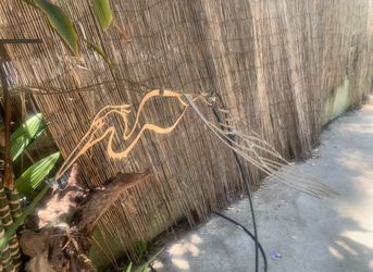 Golden crane bird yard or garden art the spins in the wind. Large made of metal.