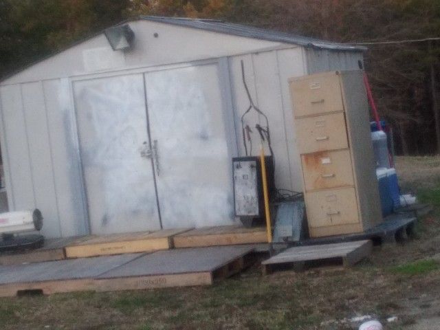 Building And Everything In It And Around It Which Is Tools Fishing Equipment And Propane Tank Heater Fans Tool Boxes A Lil Bit Of Everything 