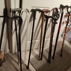 LARG COLLECTION OF VINTAGE AN NEW REG CANES AN WALKING STICKS REG CANES 8 EACH THE VINTAGE WOOD ONES ARE 18 U NEVER SEE THESE NO WERE