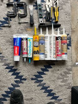 Collection of Silicone Adhesives and Sealants: Loctite, DAP, Sika, and GE.