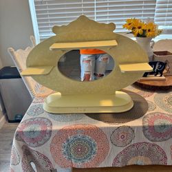 This is a vintage decorative vanity shelf with a mirror.