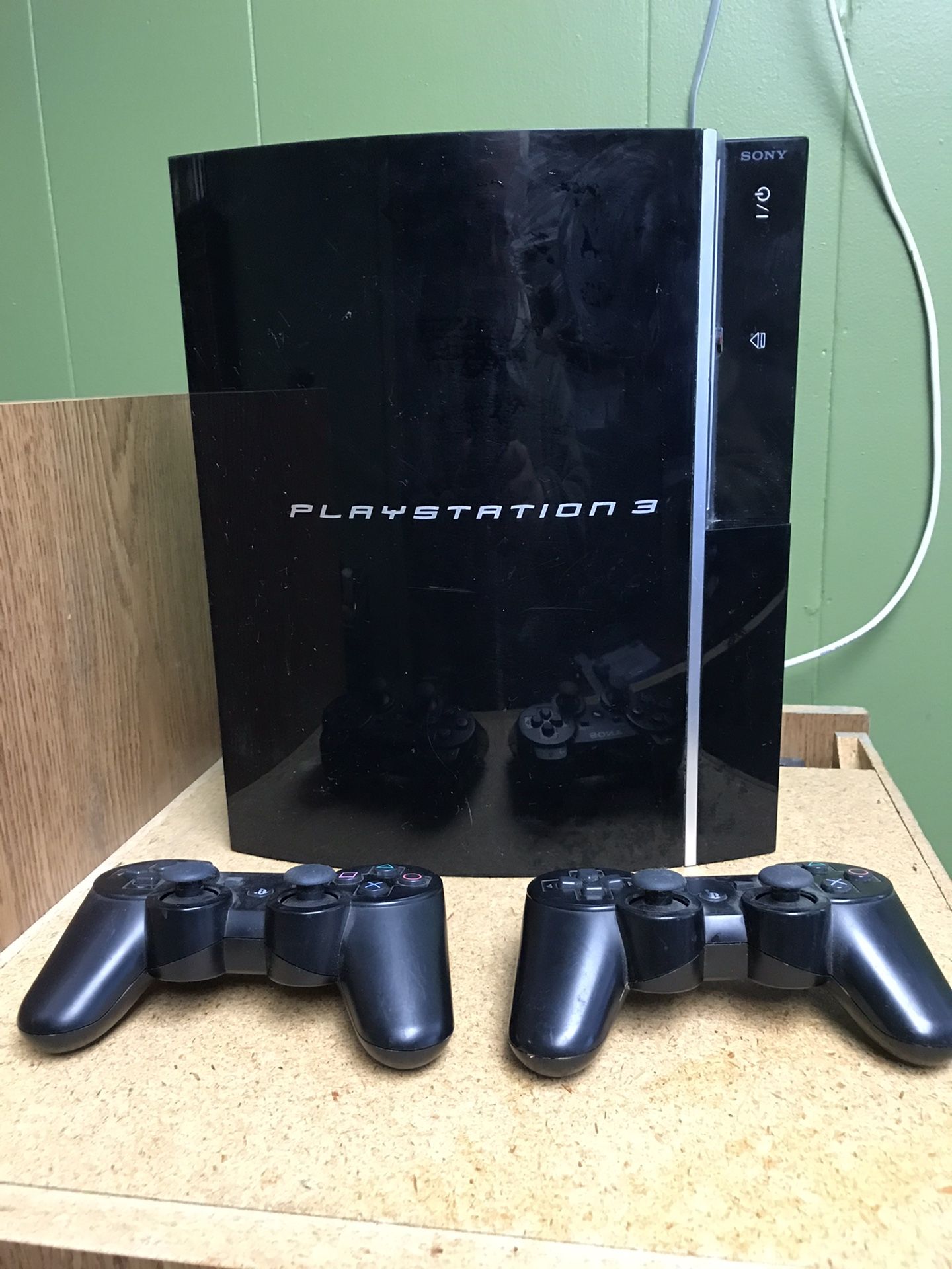 Sony PS3 with two wireless controllers.