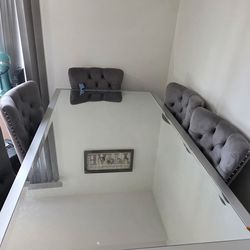 An elegant and very clean dining table with 6 chairs.