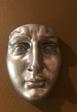 Silver resin and plaster face wall sculpture