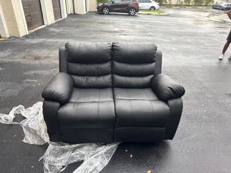 Free black recliner. One side is ripped