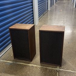 vintage 1970s speakers in dark walnut finish with black mesh