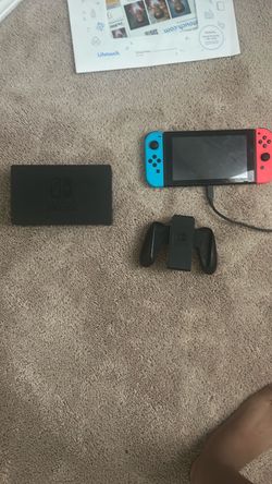 Nintendo switch with connected for bigger screens and handheld controller and charger