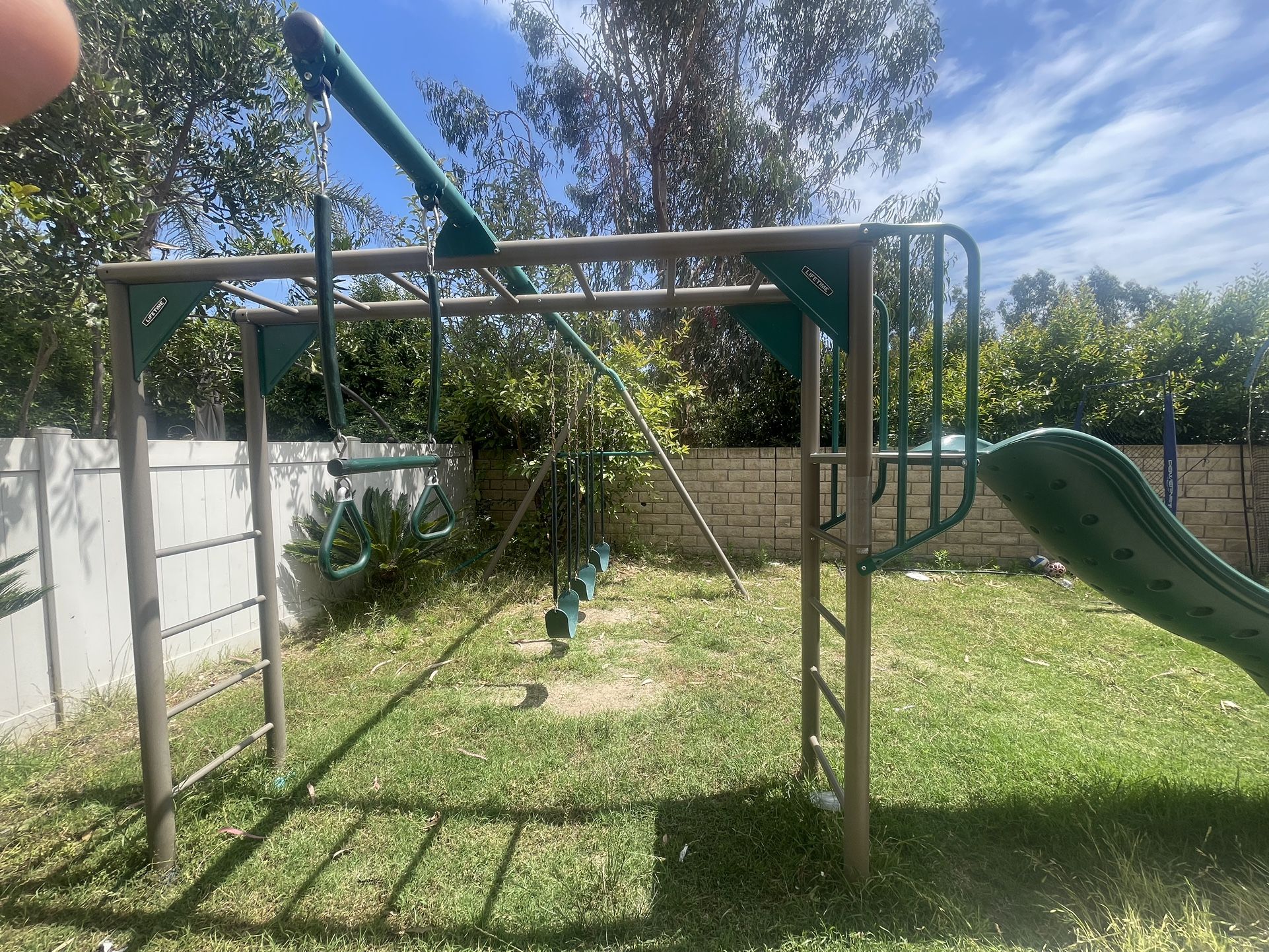 Free Lifetime Monkey Bar Adventure Swing Set with 9 Foot Wavy Slide