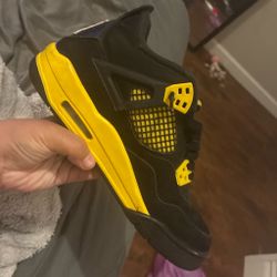 black and yellow Jordan fours