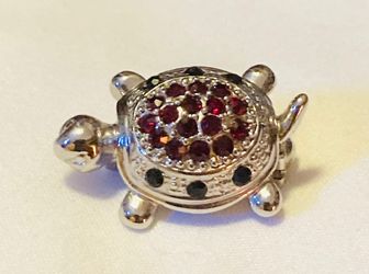 Cookie Lee lapel pin silver turtle with red and black glass stones vintage 1990s