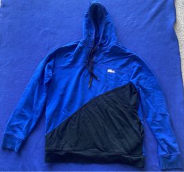 LACOSTE Hoodie with 2 Side Pockets and Glow In The Dark Lacoste Logo. Size XL. Blue & Black Color