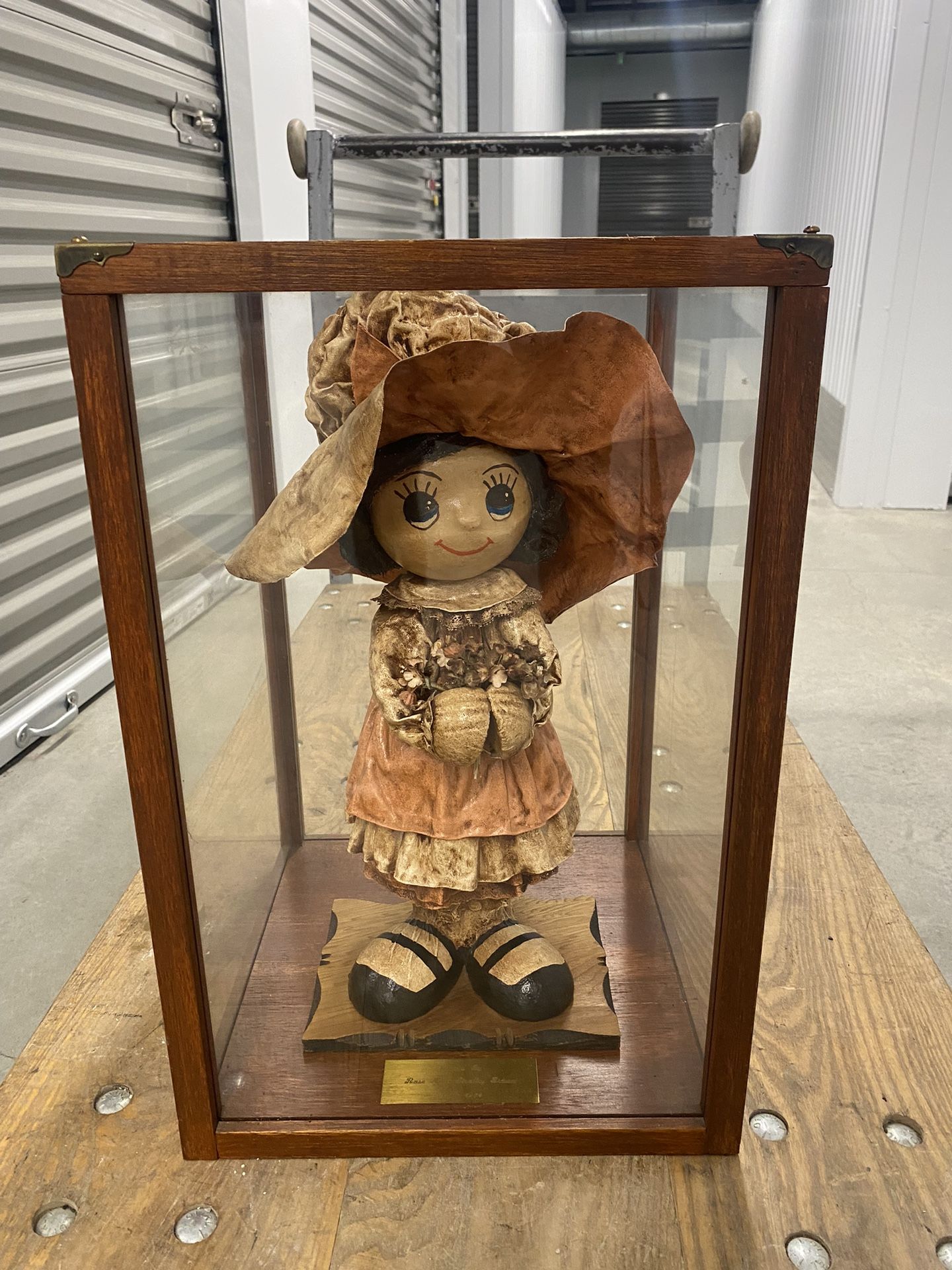 vintage papier-mâché doll and wood/glass display case with plaque