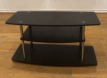 3‑tier black TV stand with metal cylinder legs