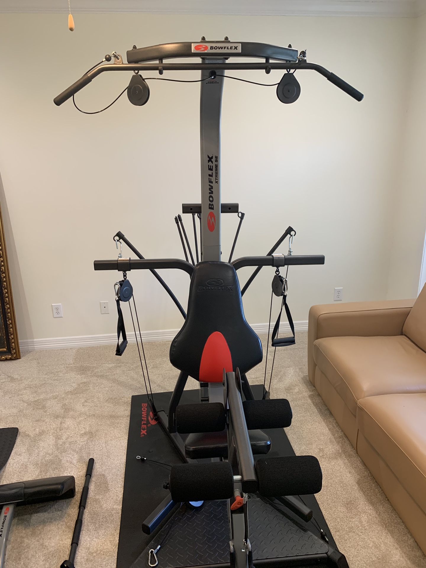 Brand new Bowflex Extreme SE + protective mat, curl bar, triceps rope, lateral pull and leg extension additions