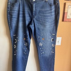 Ashley Stewart stretch distressed blue jeans for a snug, flattering fit. Eye-catching embellishments add sparkle to the legs. NWT Size 22