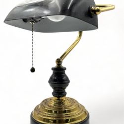 vintage banker's desk lamp featuring a curved black glass shade, a brass pillar, and a black marble base