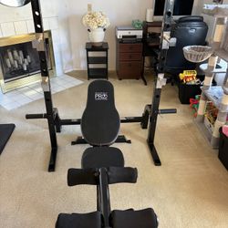 Weight bench with squat stand, leg attachment and preacher attachment by Marcy PRO