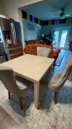 Comes with 2 chairs Elegant dining set includes four gray velvet upholstered chairs and one white wooden square table. The chairs have tufted backs, s