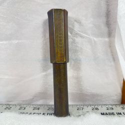 Vintage solid brass punch possibly drift punch. The top is 1 inch wide. The round part is about 7/8
