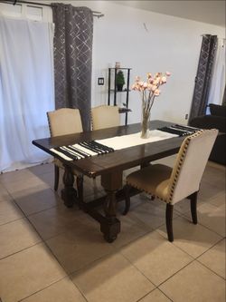 Large dining table with 3 chairs.