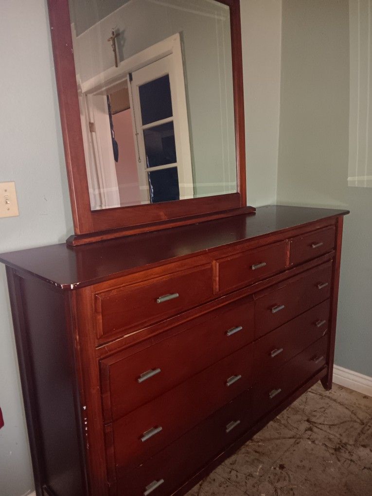 Dresser. Nightstand in a mirror.