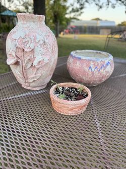Three decorative planter pots and vase