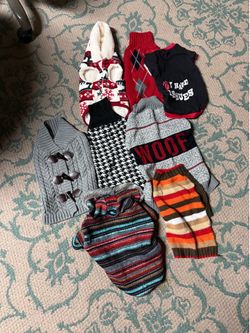Free dog sweaters perfect condition I believe they are for a medium size dog