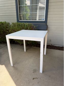 FREE A white, square, metal table is presented.