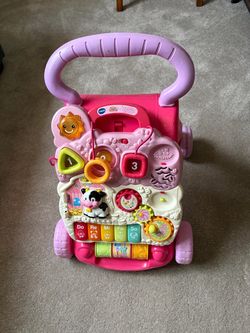 V TECH Learning Walker. Works perfectly. Comes apart to play separately.