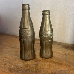 Two Vintage Brass Coca-Cola Bottles