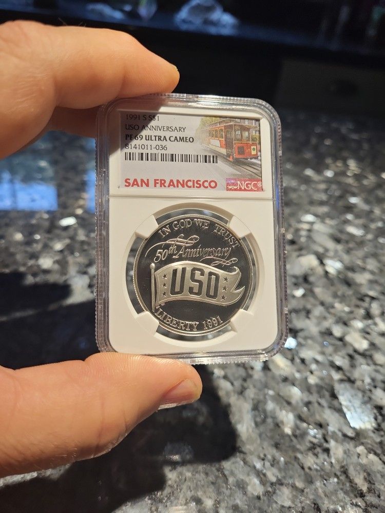1991-S USO Anniversary Modern Silver Commemorative $1 PF 69 Ultra Cameo NGC
This 1991-S USO Anniversary United Service Organizations