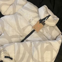 white cream north face jacket