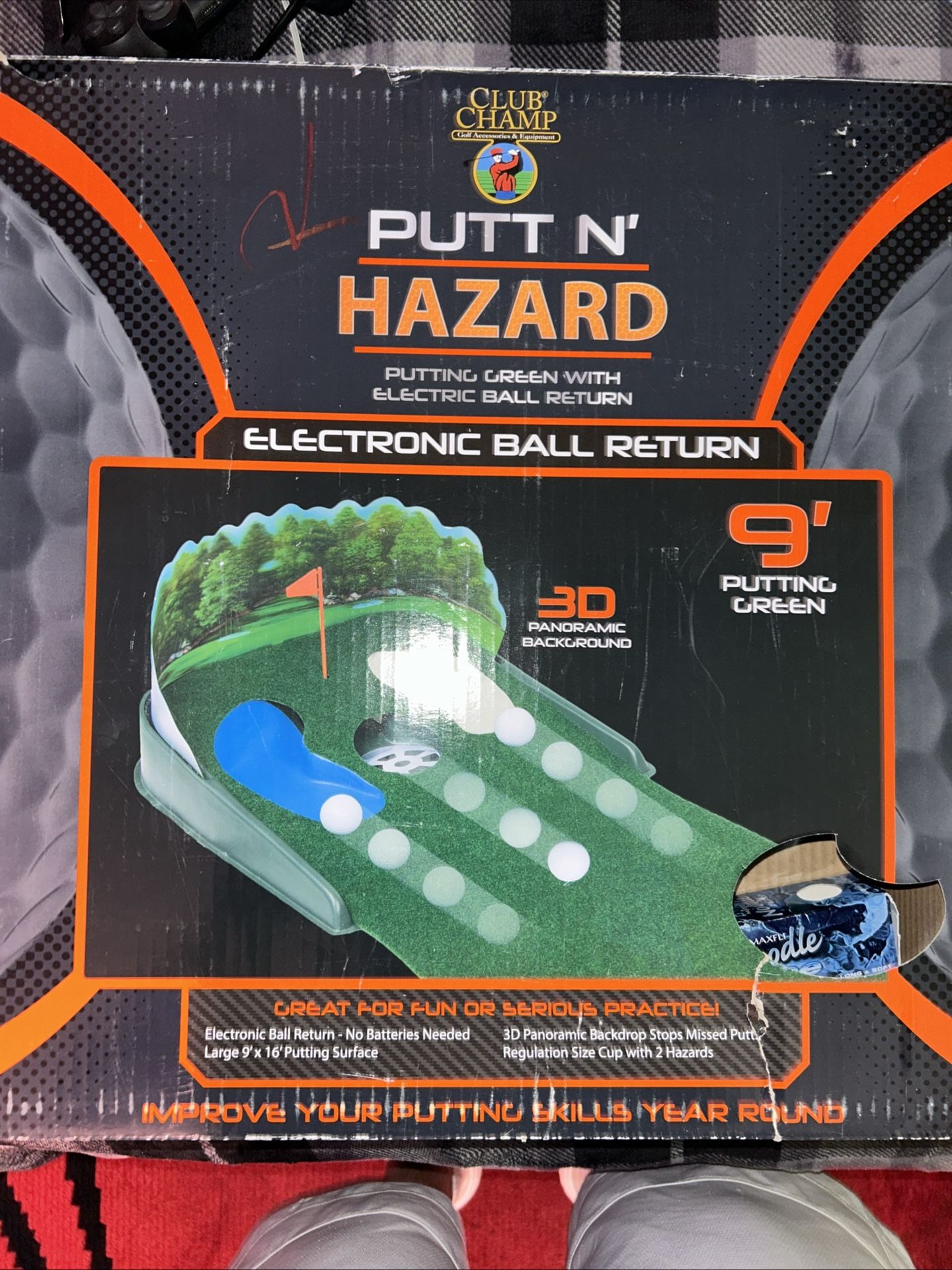 Putting hazard cutting green with retractable ball return