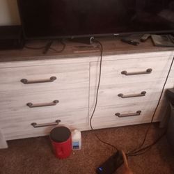 A Dresser That Has Six Drawers