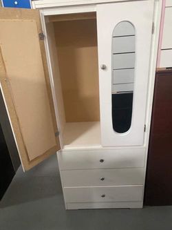Tall white closet with mirror