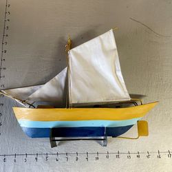 hand-painted Metal  sailboat model. It is a decorative piece Nautical or coastal-themed home decor.  