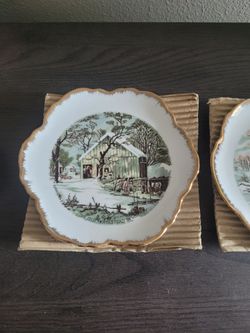 Wall decor collection set of 4 plates. New In Box.