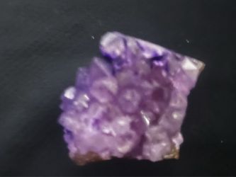 Natural amethyst crystal cluster is a purple quartz specimen with a rocky matrix base. This piece has multiple crystalline points and a varied violet