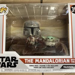 Funko Pop! Star Wars The Mandalorian with The Child From Star Wars: The Mandalorian is Mandalorian and The Child as a stylized Pop! Moment vinyl bo