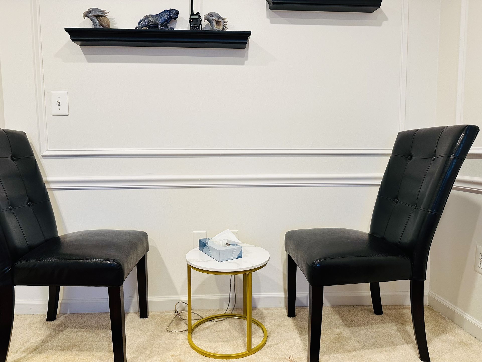 A Pair Of chairs Black Leather.