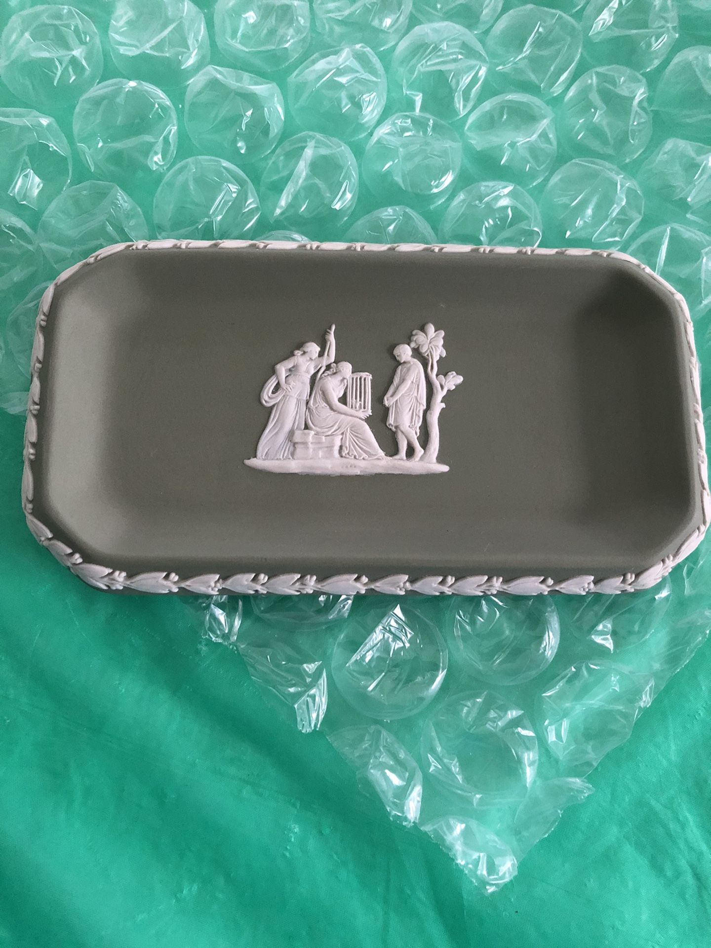 Wedgwood, England. Small dish in green stone ware with classicist scenes