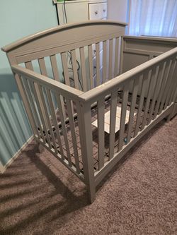 Baby crib with changing table
