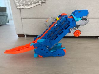 Hot Wheels City Ultimate T-Rex Transporter, Hauler Transforms into a Dino, Featured in "Let's Race"
