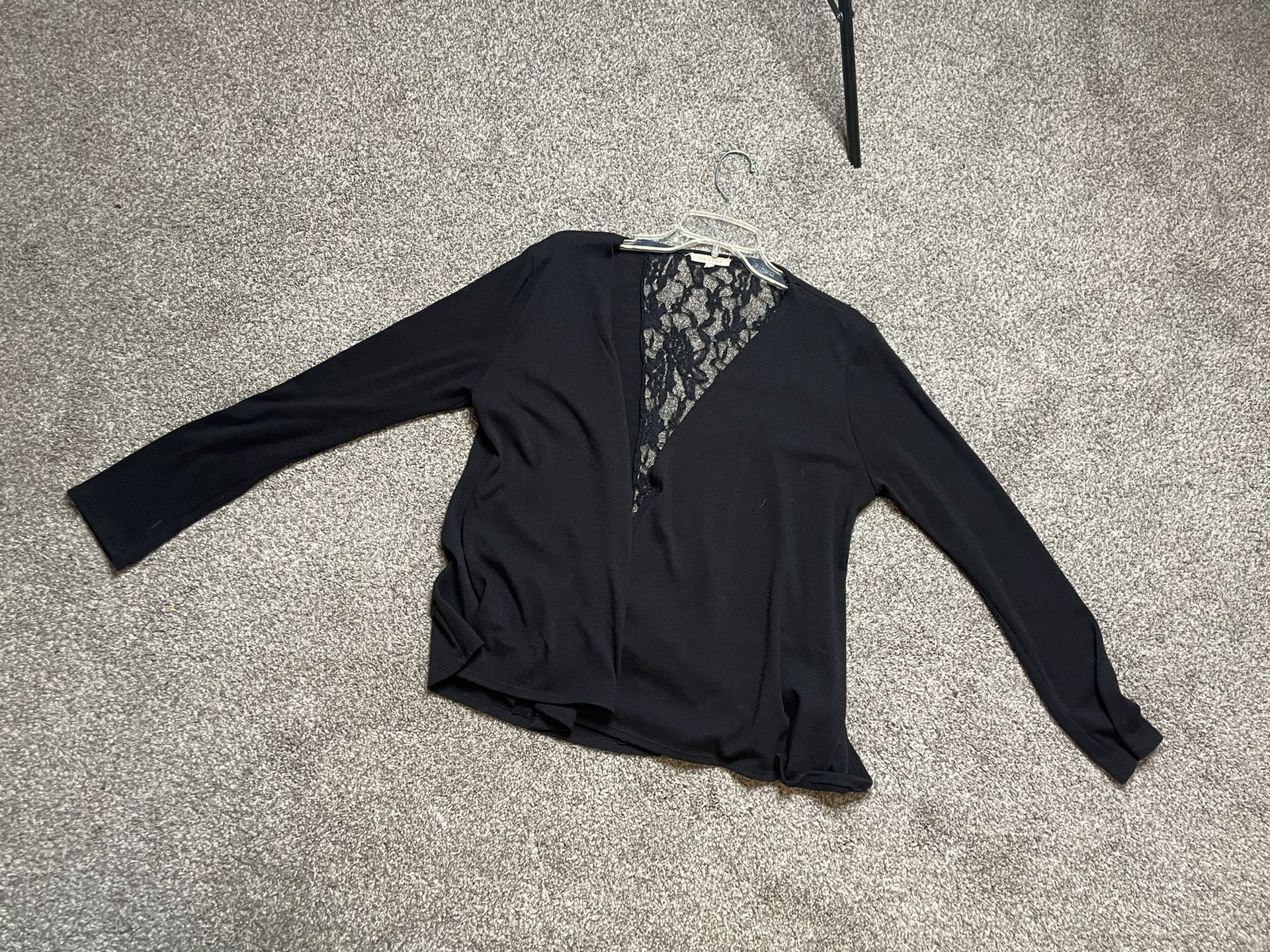 Black cardigan. Size medium. Lays down the middle of the back with gold button.
